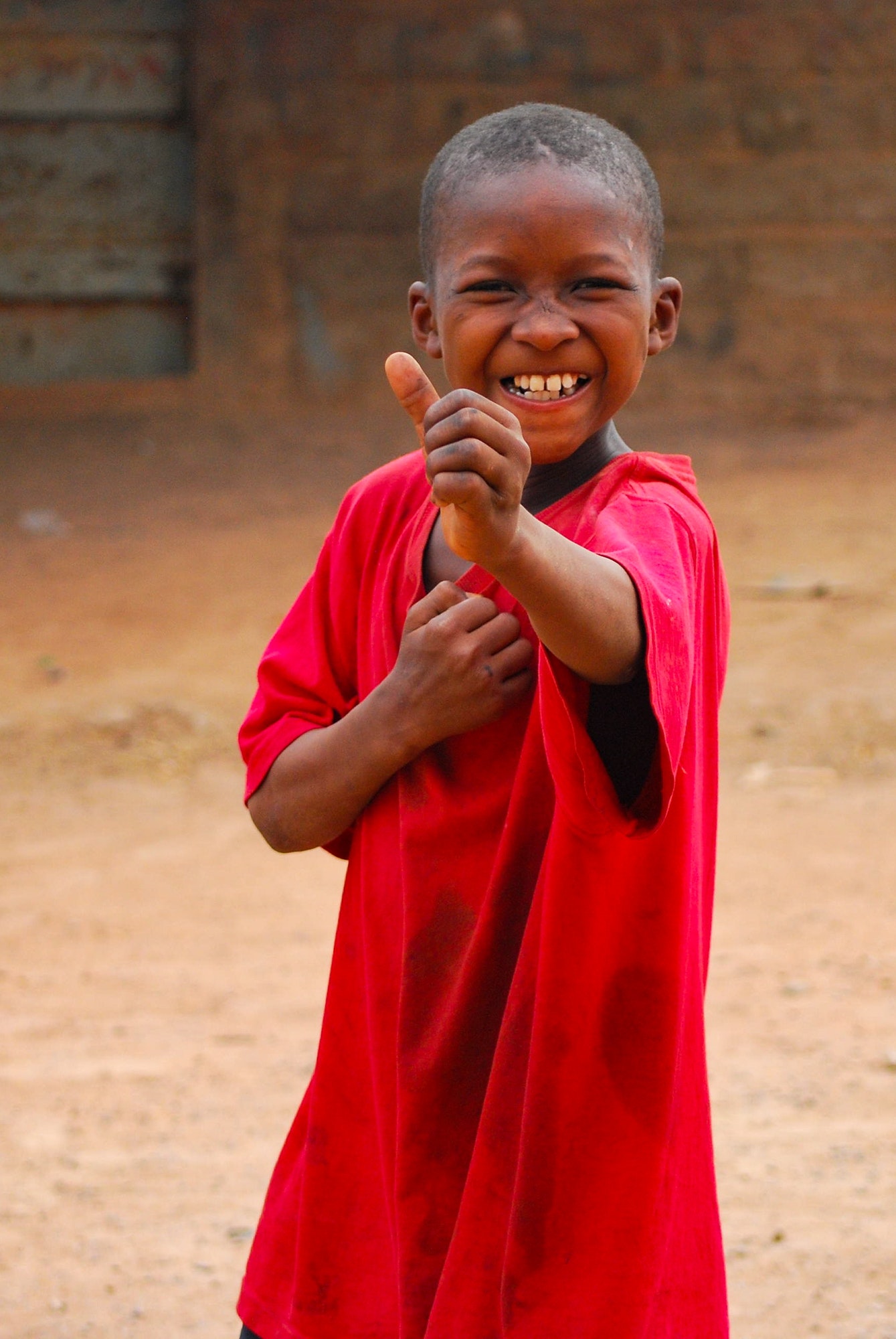african-black-boy-smiling-in-the-camera-making-a-pose-travel-africa-volunteer.jpg