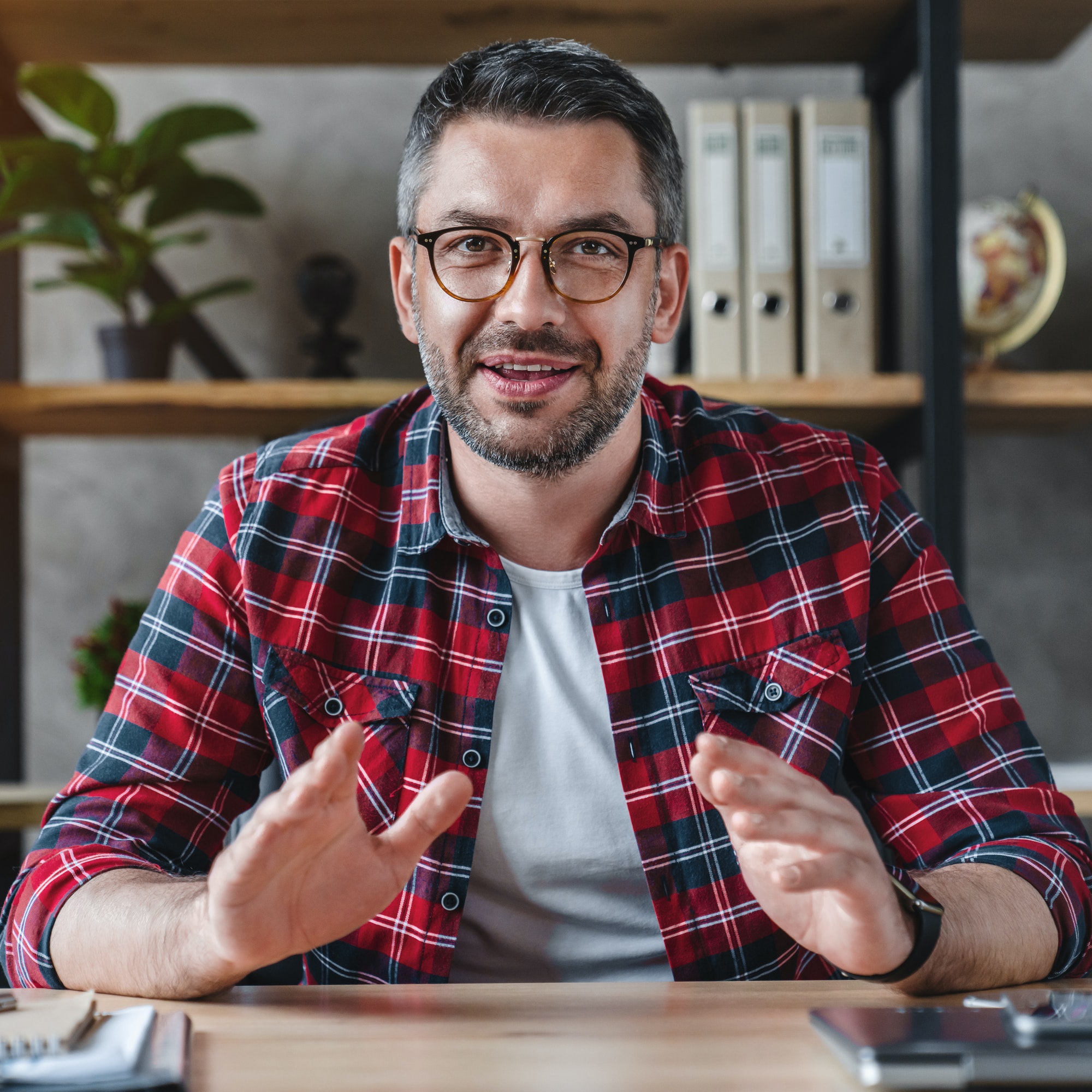 smiling-young-businessman-sit-at-desk-talk-on-webcam-having-video-call-or-conversation-with-client.jpg